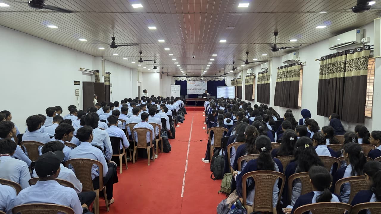 Empty seminar hall with stage and projector screen at PRPCEM Amravati